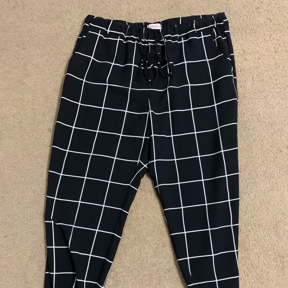 Black and white polyester pants, gathered at ankles, elastic waist, drawstring